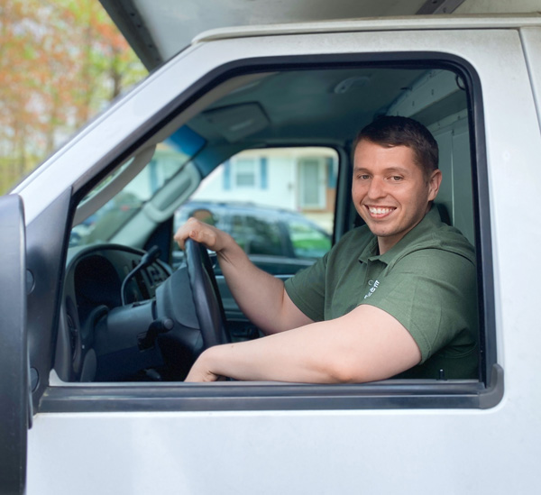 quick reaction movers truck driver smiling