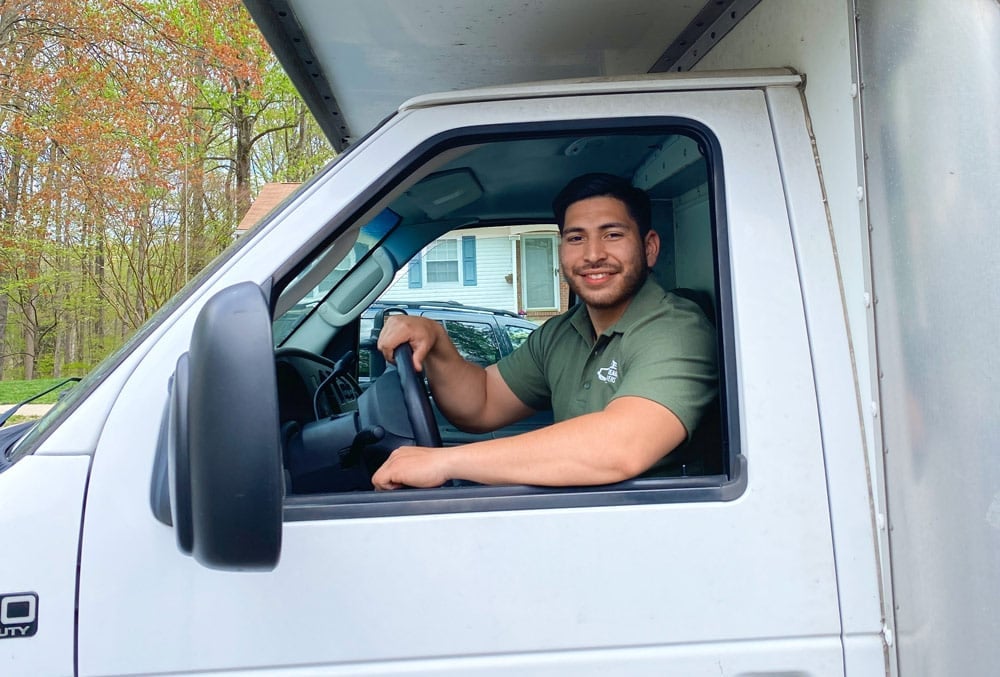 Quick Reaction mover in the driver's seat of a moving truck