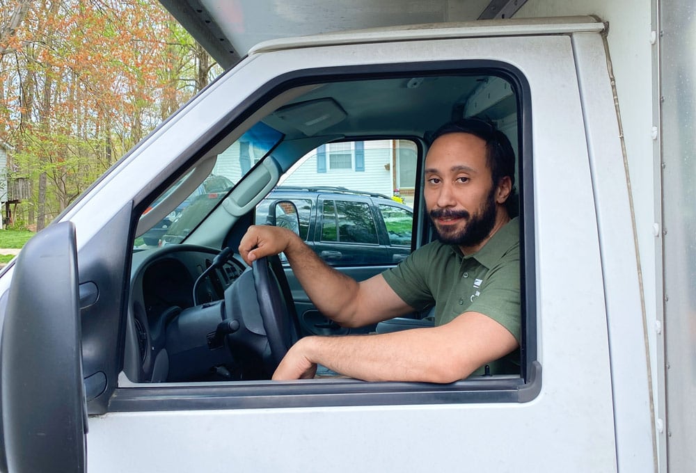 Quick Reaction mover in the driver's seat of a moving truck