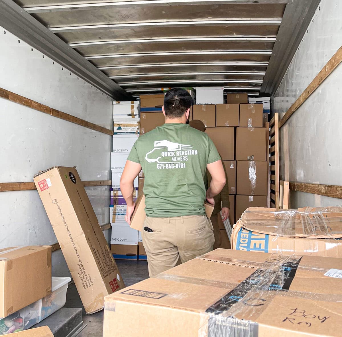 Mover stacking boxes inside a moving truck
